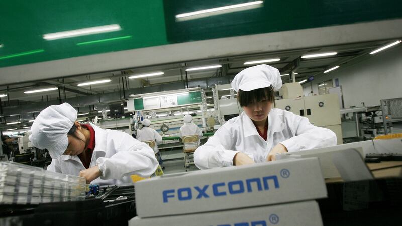 Employees work inside a Foxconn factory in the township of Longhua in the southern Guangdong province of China. Photograph: Reuters