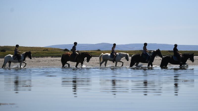 Horses are ridden into the water on Rusheen beach during sunny weather in Co Galway. Photograph: Reuters