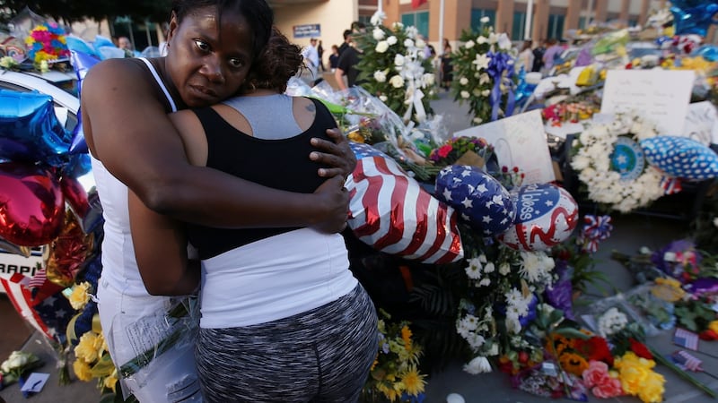 A friend supports Keaka Wallace (right) who says she was a patrol partner of slain Dart officer Brent Thompson, weeping at a makeshift memorial at Dallas Police headquarters following the multiple police shooting in Dallas, Texas, US, July 8th, 2016. File photograph: Carlo Allegri/Reuters
