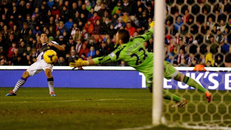 Luis Suarez of Liverpool shoots past Jack Butland of Stoke City to score his second and Liverpool’s fourth  at Britannia Stadium. Photograph: Laurence Griffiths/Getty Images