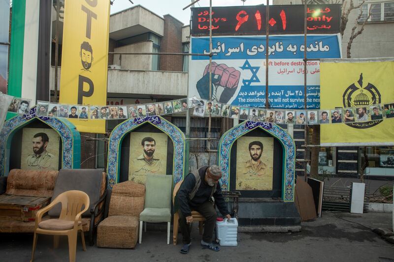 A man in Tehran on Saturday sits in front of countdown to Israel's doomsday. Photograph: Majid Saeedi/Getty Images