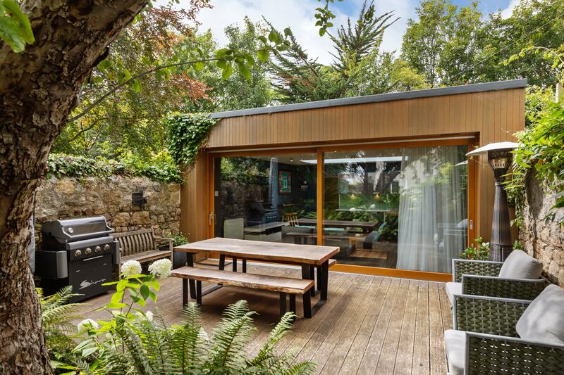 Barbecue deck with garden room at end of garden