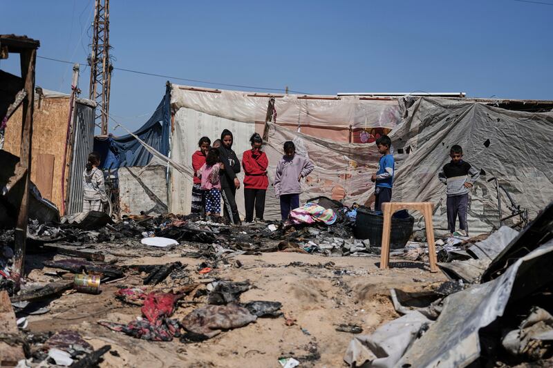 Palestinians inspect the remains of a displacement tent hit by an Israeli airstrike. Photograph: Abdel Kareem Hana/AP