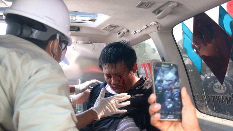 A demonstrator is tended by medics in an ambulance after police fired water cannon on demonstrators in Naypyitaw on Tuesday. Photograph: Maung Lonlan/EPA