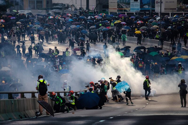 Demonstrators are shrouded in a cloud of tear gas outside the central government offices  in the Admiralty district of Hong Kong. Photograph: Kyle Lam/Bloomberg