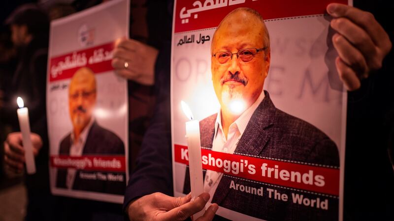 People hold posters picturing Saudi journalist Jamal Khashoggi and lightened candles during a gathering outside the Saudi Arabia consulate in Istanbul, on Thursday. Photograph: Yasin Akgul/AFP/Getty Images