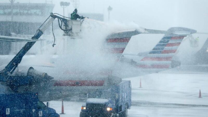 An airport worker de-ices an airplane at LaGuardia Airport, New York. Photograph: Shannon Stapleton/Reuters