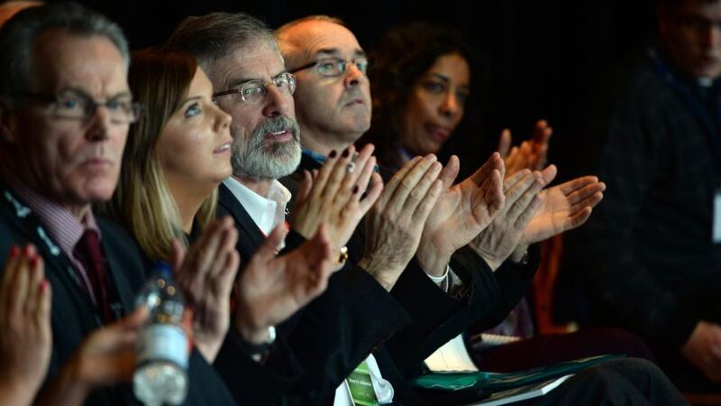 Gerry Adams listening to Derek Moore of the Londonderry Bands Forum at the Sinn Féin Ardfheis  in Derry. Photograph: Dara Mac Dónaill