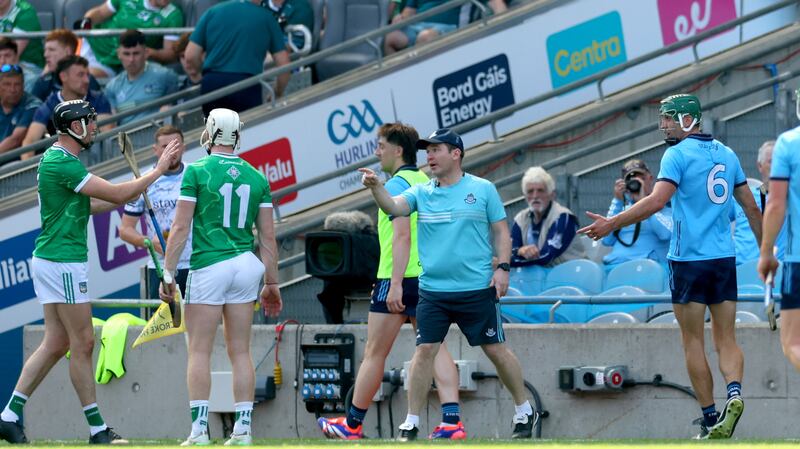Chris Crummey (6) leaves the field after being red carded during Saturday's quarter-final while Dublin manager Niall Ó Ceallacháin has words with Limerick's Gearóid Hegarty. Photograph: James Crombie/Inpho