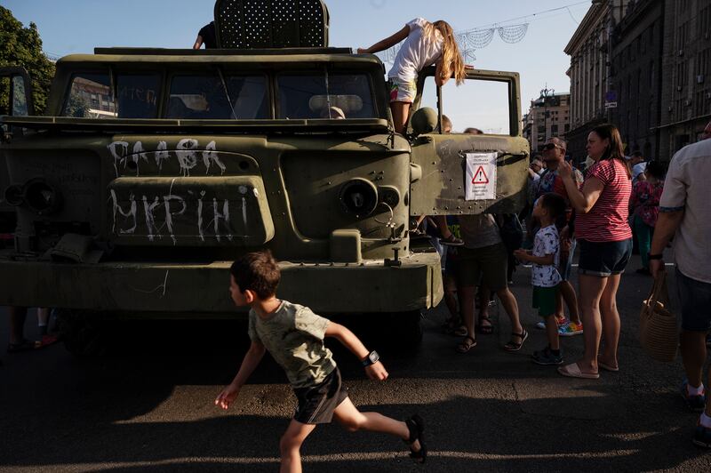 Children play near a destroyed Russian military vehicle in central Kyiv on Sunday. Photograph: Lynsey Addario/New York Times