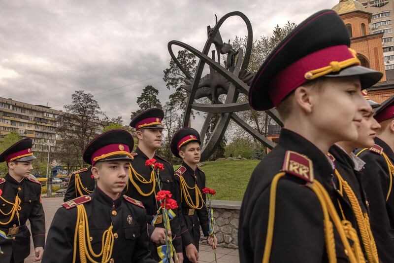 Ukrainian cadets visit the monument for Chernobyl victims in Kyiv, Ukraine. Photograph: Roman Pilipey/Getty Images