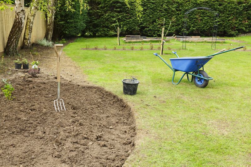 Neat and tidy: Preparing a freshly dug flower bed for planting. 