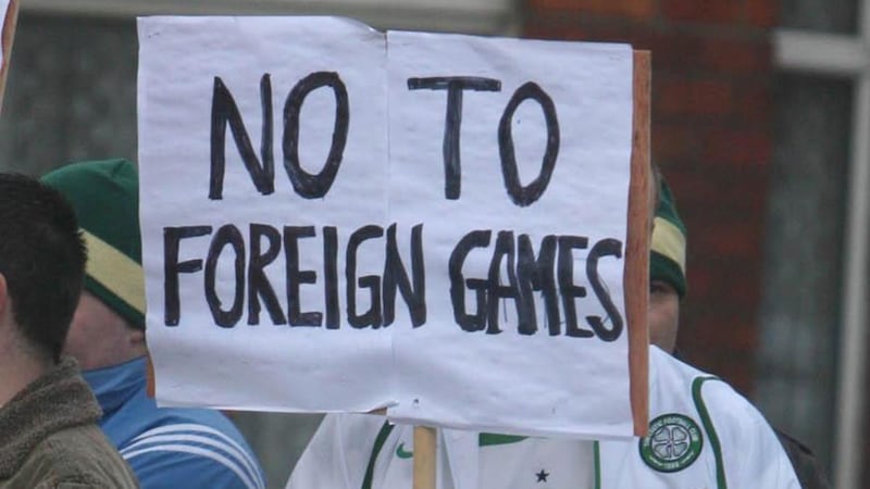 A protester wearing a Celtic football top holds a sign saying ’No to foreign games’ at Croke Park ahead of the Ireland v England Six Nations match. Photograph:  Liam McBurney/PA Wire