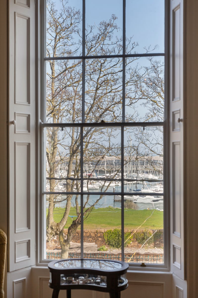Tall sash window overlooking Dún Laoghaire harbour with working shutters