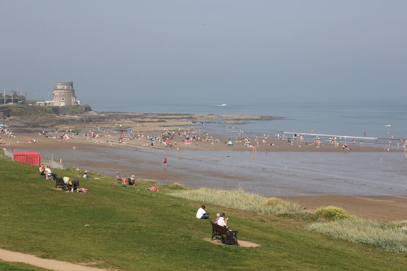 People enjoy the good weather at Portmarnock. Photograph: Nick Bradshaw/The Irish Times