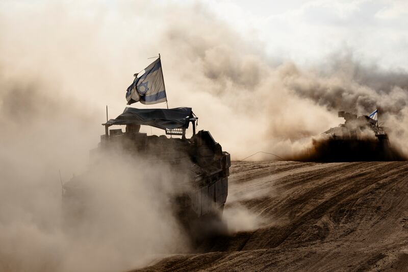 Israeli armored personnel carriers move along the border with the Gaza Strip in southern Israel on Wednesday. Photograph: Amir Levy/Getty