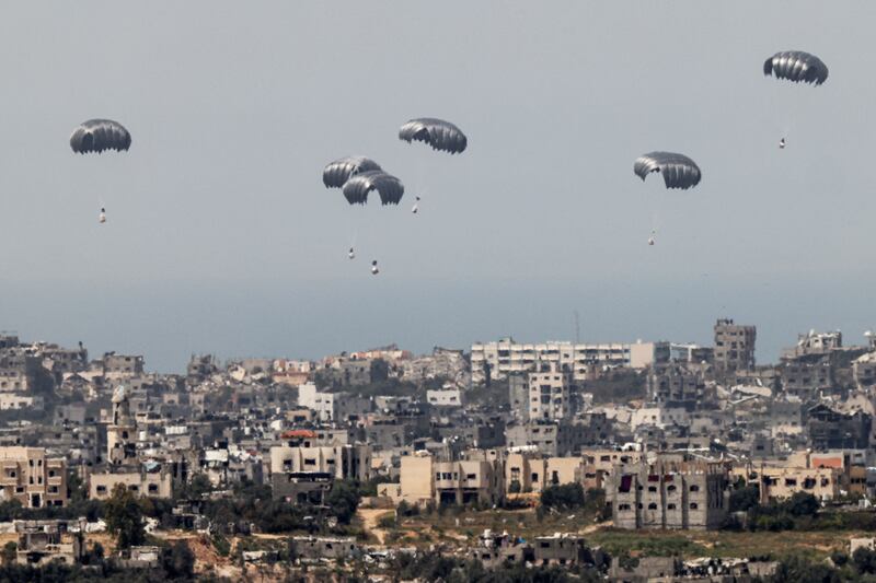Humanitarian aid is dropped into besieged Palestinian territory on Thursday. Photograph: Jack Guez/AFP via Getty