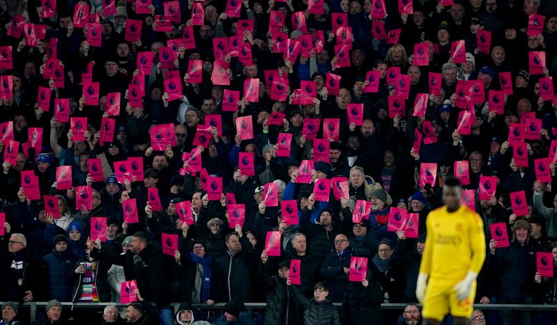 Everton fans hold signs protesting against the Premier League following their points deduction. Photograph: Peter Byrne/PA Wire