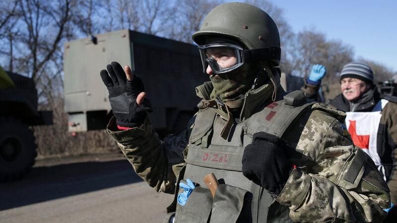 Ukrainian serviceman waves to his comrades as they leave territory around Debaltseve. Photograph: Anastasia Vlasova/EPA