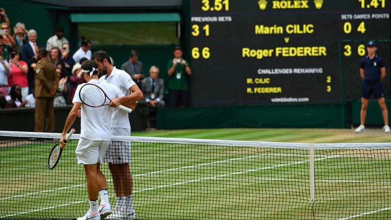Roger Federer and Marin Cilic shake hands after the Swiss had completed a straight sets win in the Wimbledon final. Photograph: Glyn Kirk/AFP