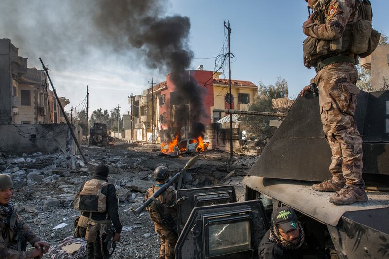 Iraqi soldiers surveying the scene of an Islamic State suicide car bombing in Mosul, Iraq in 2017. Photograph: Ivor Prickett/New York Times
                      