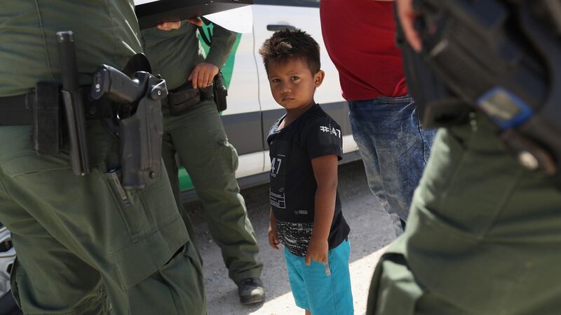 US border patrol agents take into custody a father and son from Honduras near the US-Mexico border on June 12th, near Mission, Texas. The asylum seekers were then sent to a US Customs and Border Protection (CBP) processing center for possible separation. Photograph: John Moore/Getty Images
