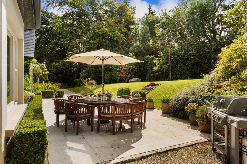 Barbecue and seating on the granite patio at rear.
