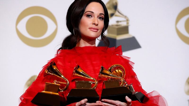 Kacey Musgraves poses backstage with her four awards, including for Album of the Year for Golden Hour. Photograph: Mario Anzuoni/Reuters