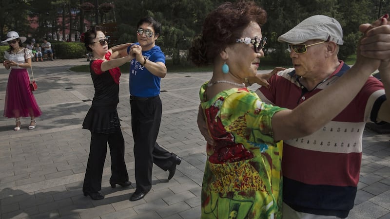 Chinese couples dance in Ritan Park – a popular spot for elderly citizens –  in Beijing, China. By 2030 one quarter of China’s population is expected to be aged 60 or older. Photograph: Kevin Frayer/Getty Images