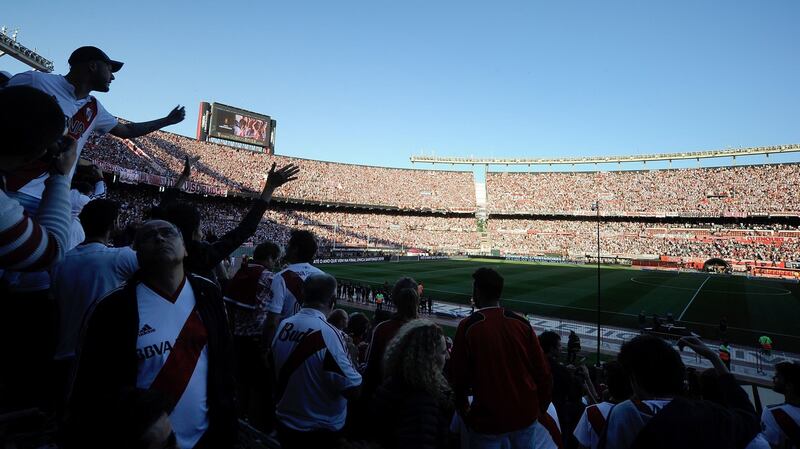 Supporters of River Plate wait at the Monumental stadium in Buenos Aires for the decision of authorities before it was decided that the  Copa Libertadores second leg  was postponed. Photograph:  Javier Gonzalez Toledo/AFP/Getty Images