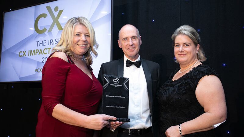 Maria Svejdar, awards judge, presents the CX Impact in Financial Services award to John Moclair and Osna O'Connor, Bank of Ireland Global Markets.