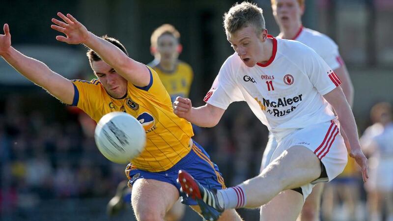 Tyrone’s Mark Kavanagh gets his shot away desptie the efforts of Evan McGrath. Photograph: Donall Farmer/Inpho