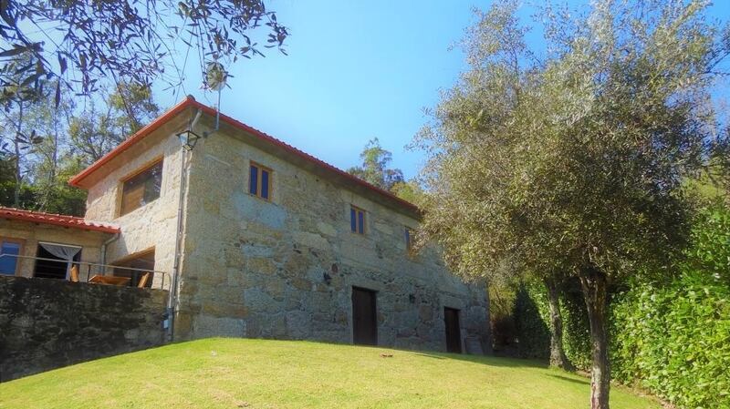This restored mill house in Portugal has a garden filled with lemon, orange, plum and olive trees