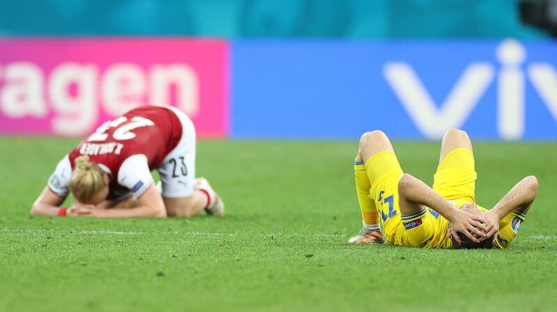 Ukraine’s Mykola Matviyenko and Austria’s Xaver Schlager react after the full time whistle in Bucharest. Photograph: Marko Djurica/Getty/AFP