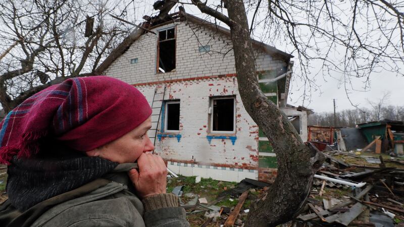 A  woman inspects the debris of her home  on the outskirts of Chernihiv after it was severely damaged by shelling. Photograph: Sergey Dolzhenko/EPA