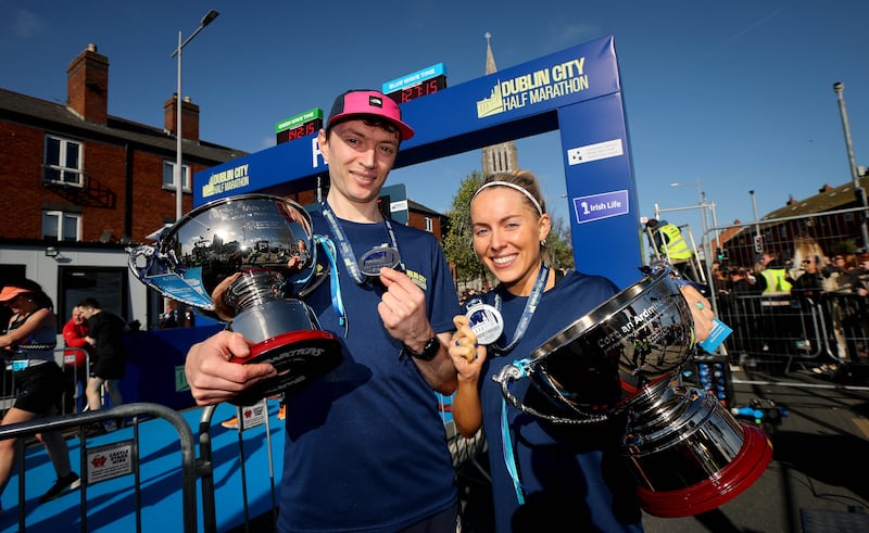 Men’s race winner Killian Mooney and women’s race winner Nichola Sheridan with their Champion’s trophies. Photograph: Ryan Byrne/Inpho