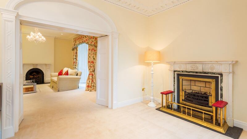 Reception rooms at the front of the house flow into one another: the front porch opens into a reception hall which opens through an arch into the drawingroom.