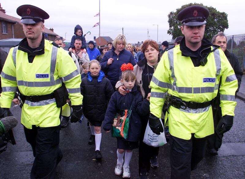 Catholic schoolchildren being escorted to Holy Cross primary school in the Protestant Ardoyne area of Belfast. Photograph: Paul Faith/PA