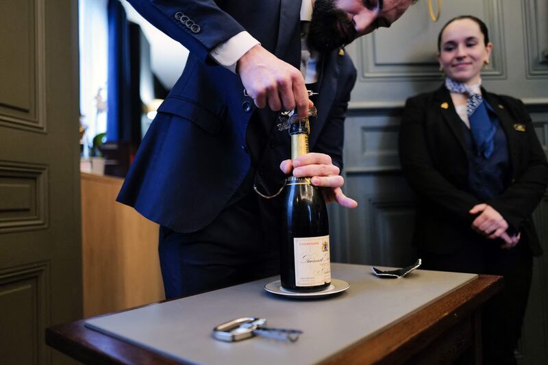 Sommelier Maxime Valery opens a bottle of Ruinart champagne dating back to 1926, lost in chef Paul Bocuse's restaurant cellar, in Colonges-au-Mont-d'Or, near Lyon, last month. Photograph: Olivier Chassignole/AFP/Getty