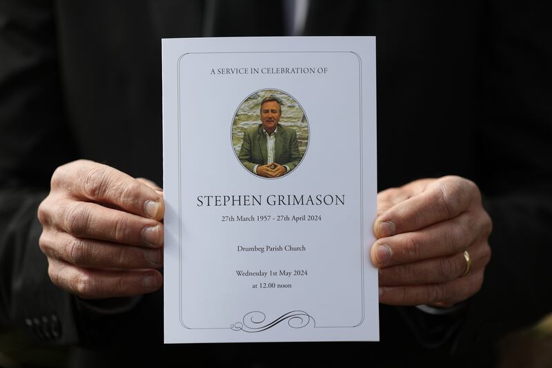 A mourner holds the order of service for the funeral mass of former BBC Northern Ireland political editor Stephen Grimason, at Drumbeg parish church in Dunmurry, Belfast. Photograph: Liam McBurney/PA Wire
