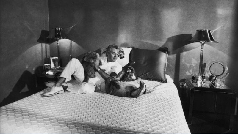 Fashion designer Giorgio Armani playing w his dogs at home. Photograph: Getty Images