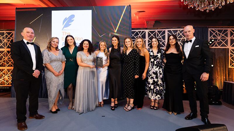 Denise McMorrow, awards judge, presents the best graduate training programme award to the Bristol Myers Squibb team