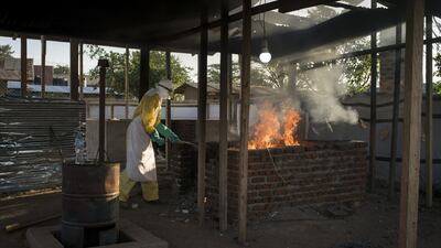 A worker in protective wear burns items that were used in the quarantined area at an Ebola treatment center in Beni, Democratic Republic of Congo in December, 2018. Photograph: Diana Zeyneb Alhindawi/The New York Times