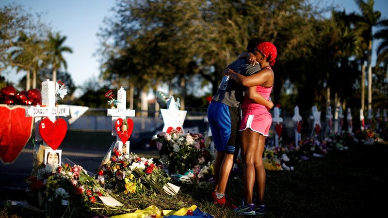Adin Chistian, a student at Marjory Stoneman Douglas High School, embraces his mother Denyse, at a memorial to the victims of the shooting in Parkland, Florida. Photograph: Carlos Garcia Rawlins/Reuters