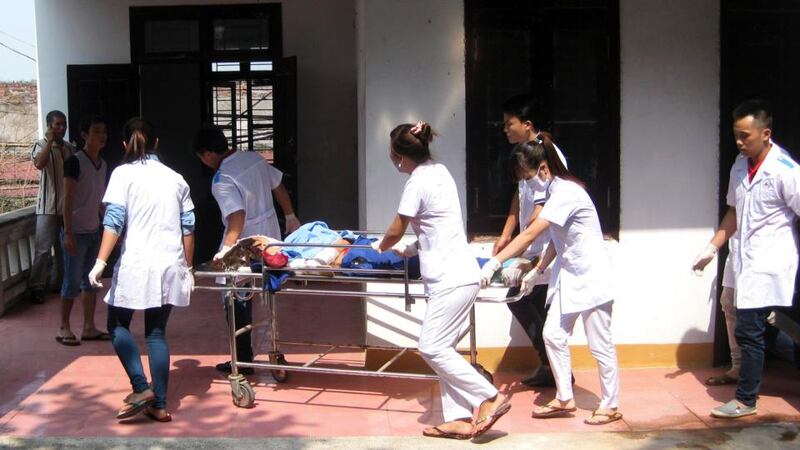 Medical personnel move the body of a victim who died an explosion at a fireworks factory in a military compound in Vietnam’s northern Phu Tho province. Photograph: Reuters