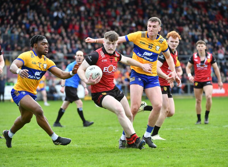 Odhran Murdock of Down is closed down by Ikem Ugweru and Emmet McMahon of Clare during their Division Three NFL game in Newry. Photograph: Andrew Paton/Inpho