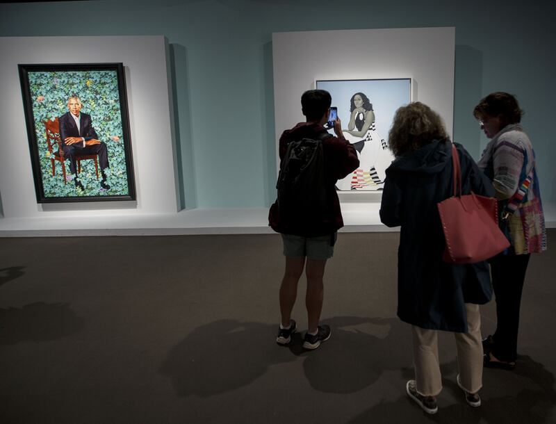 Visitors to the Museum of Fine Arts Boston take in the portraits of former US president Barak Obama by Kehinde Wiley and Michelle Obama by Amy Sherald. Photograph: EPA