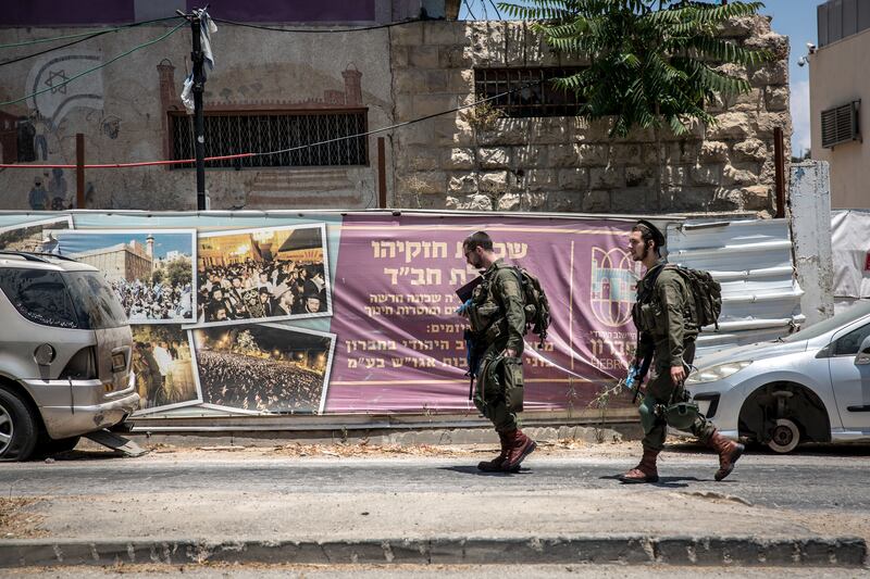 Israeli soldiers walk along a street in central Hebron, which is under Israeli military occupation. Photograph: Sally Hayden