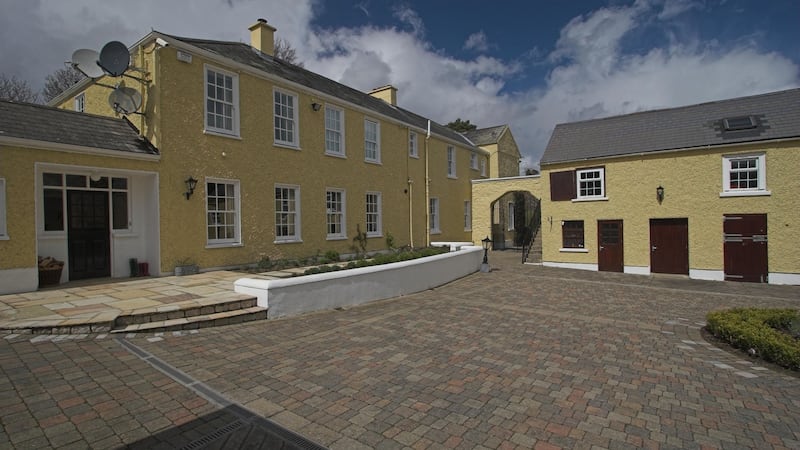 The neat courtyard is ringed by one- and two-storey stone outbuildings that include 10 loose boxes.