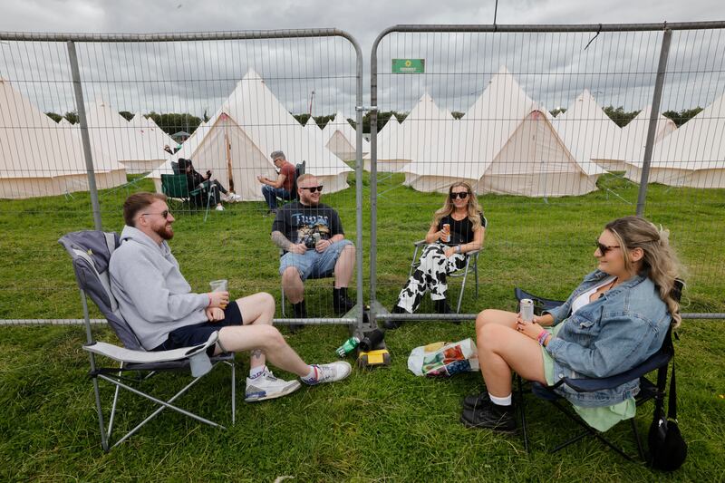 Electric Picnic 2024: Michael Dunne, Ian Reilly, Tracey Mulligan and Ciara Mulligan, from Tallaght and Balbriggan, speak across the divide between the Silver and Cosmic Avenue campsites on Friday. Photograph: Alan Betson

